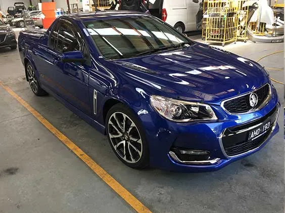 The blue Holden ute after fallout removal, gloss restored