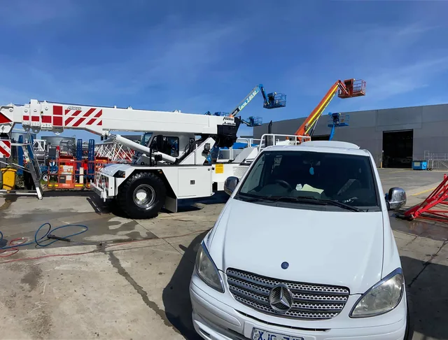 Mobile crane and a Mercedes hatch awaiting treatment